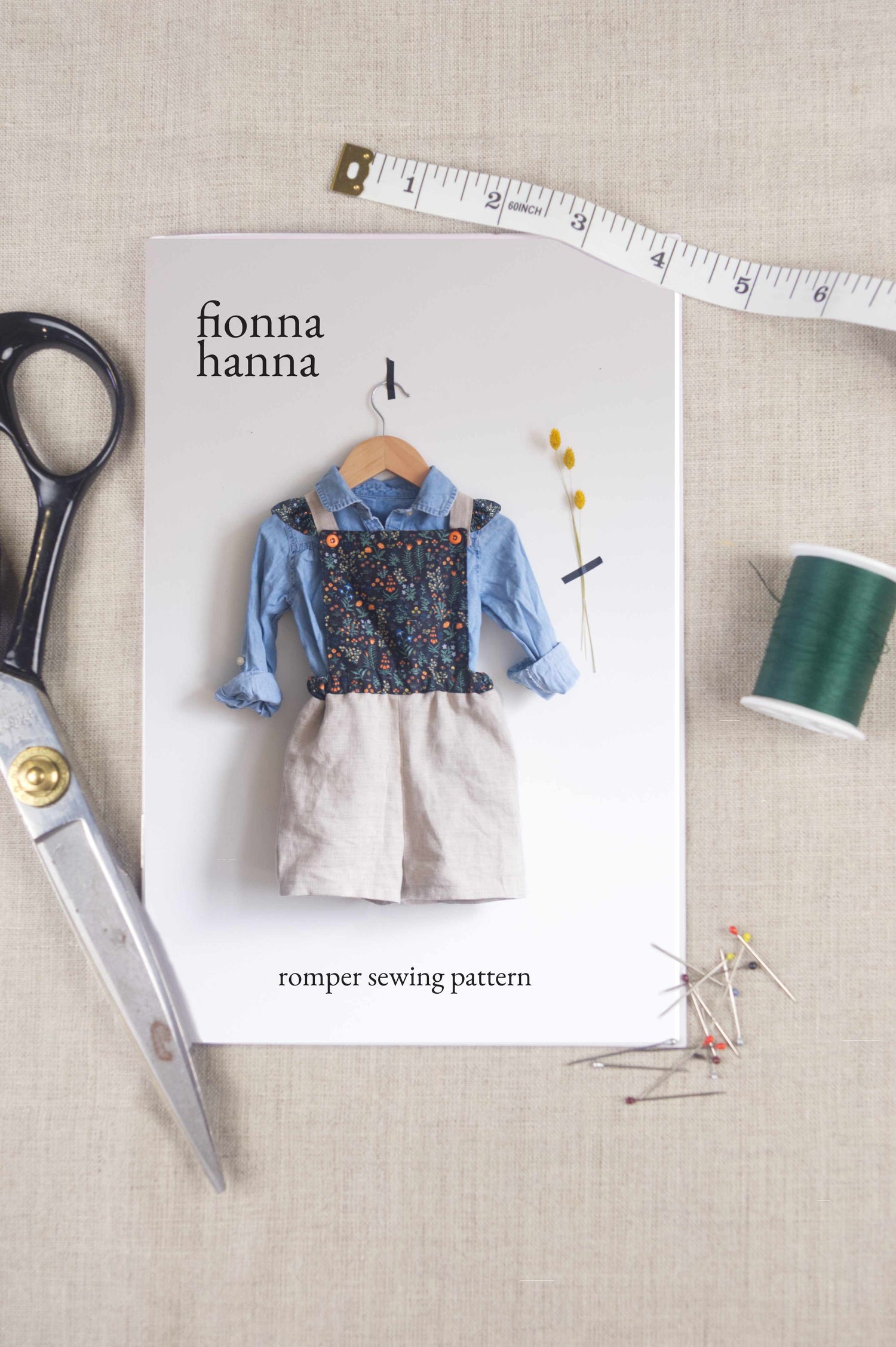 children's sewing patterns layout with a pattern, scissors and pins