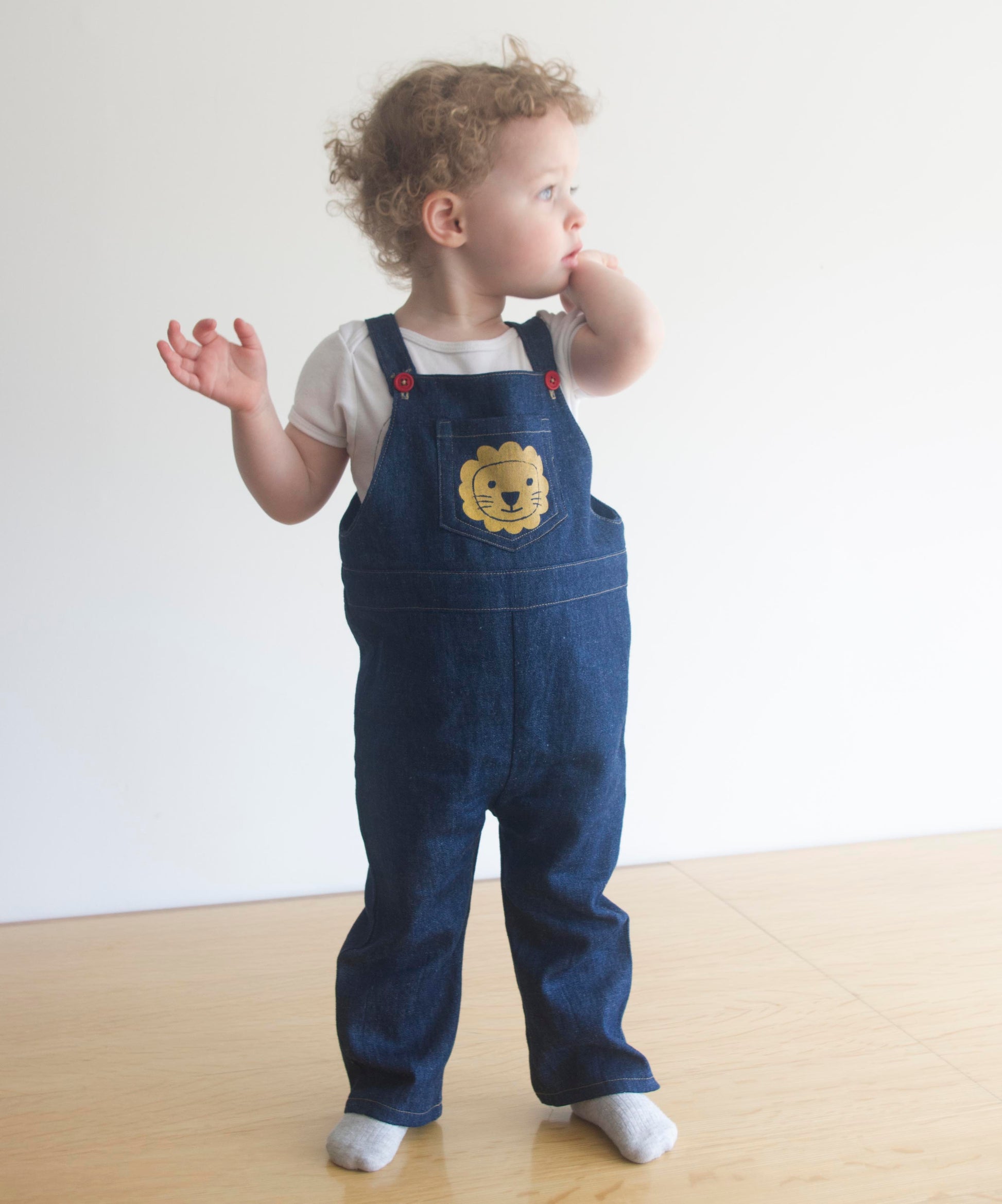 small child wearing overalls